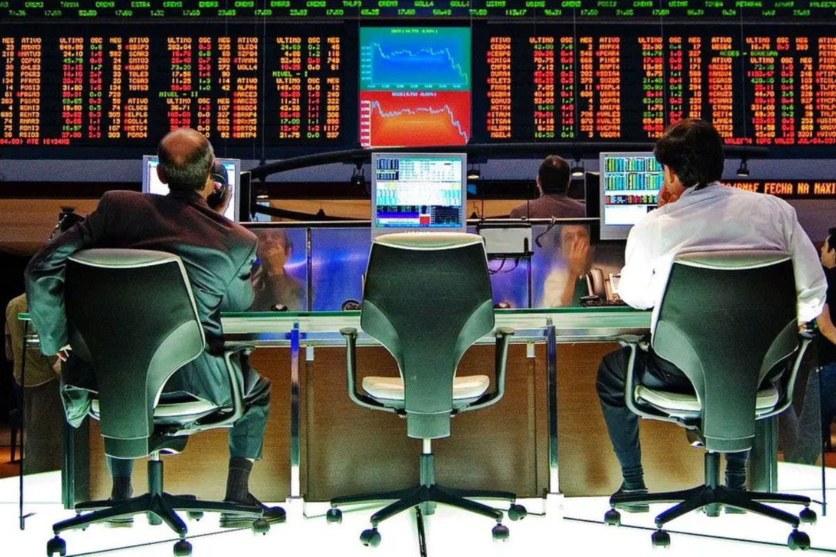 people sitting at a desk looking at a computer screen