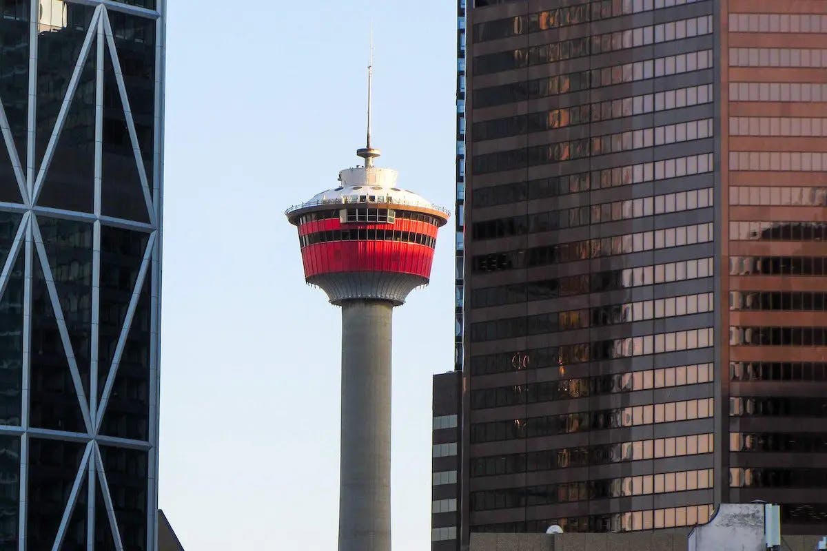 A towering building featuring a red and white tower, showcasing architectural grandeur and striking color contrast.