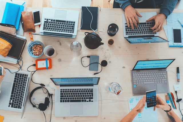 Team working on laptops at a desk