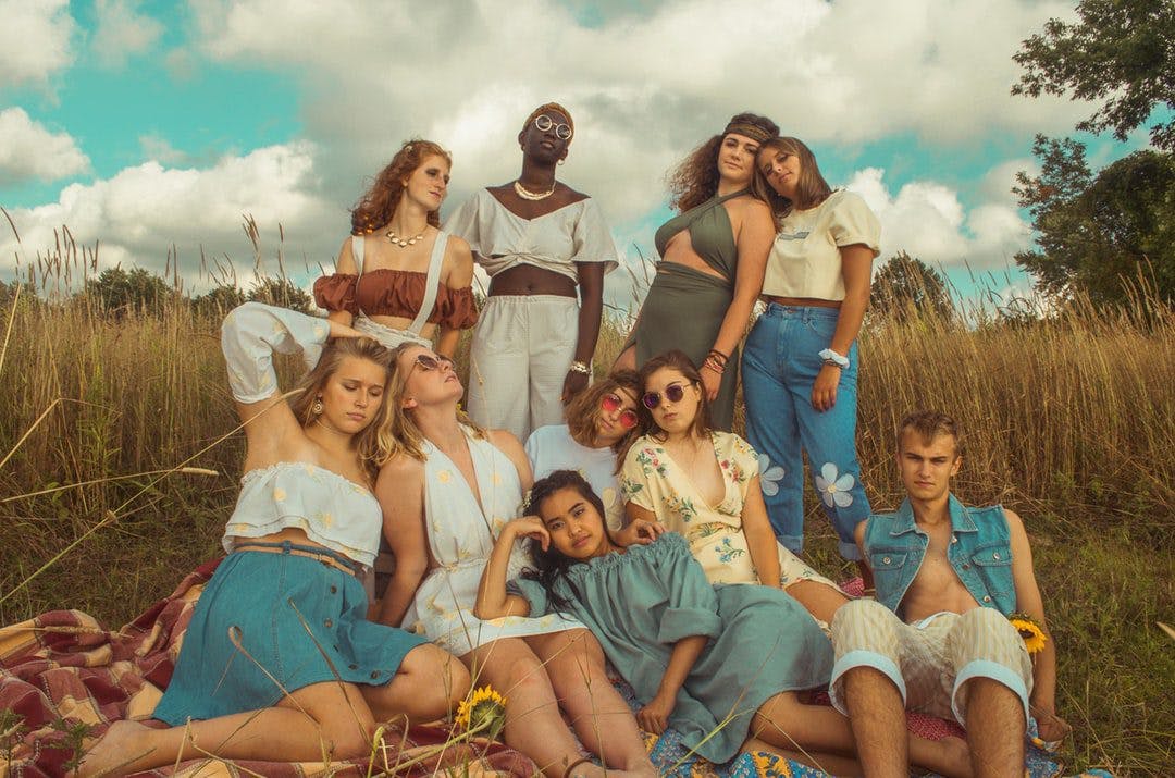 Young group posing for photo in field.