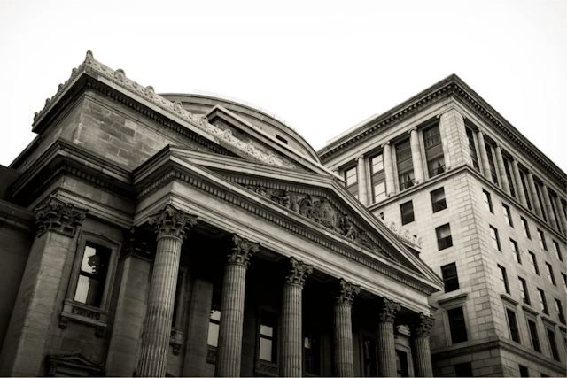 Monochrome image of a building with classic columns