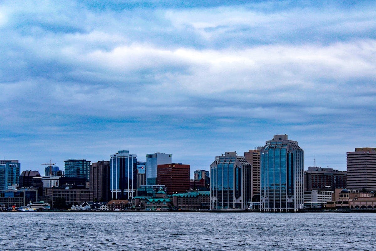 a city skyline with water and clouds