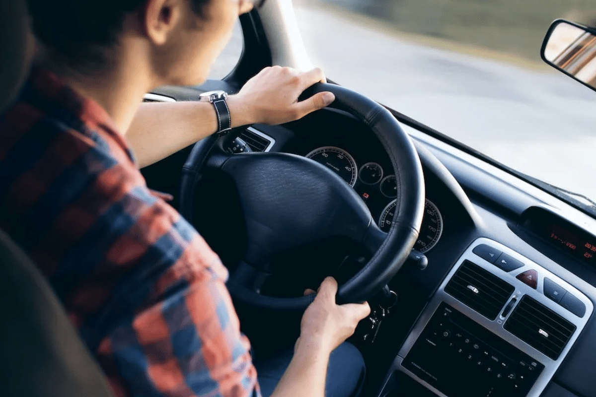 a person holding a steering wheel