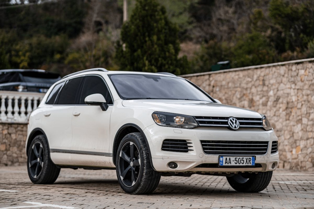 a white car parked on a brick road