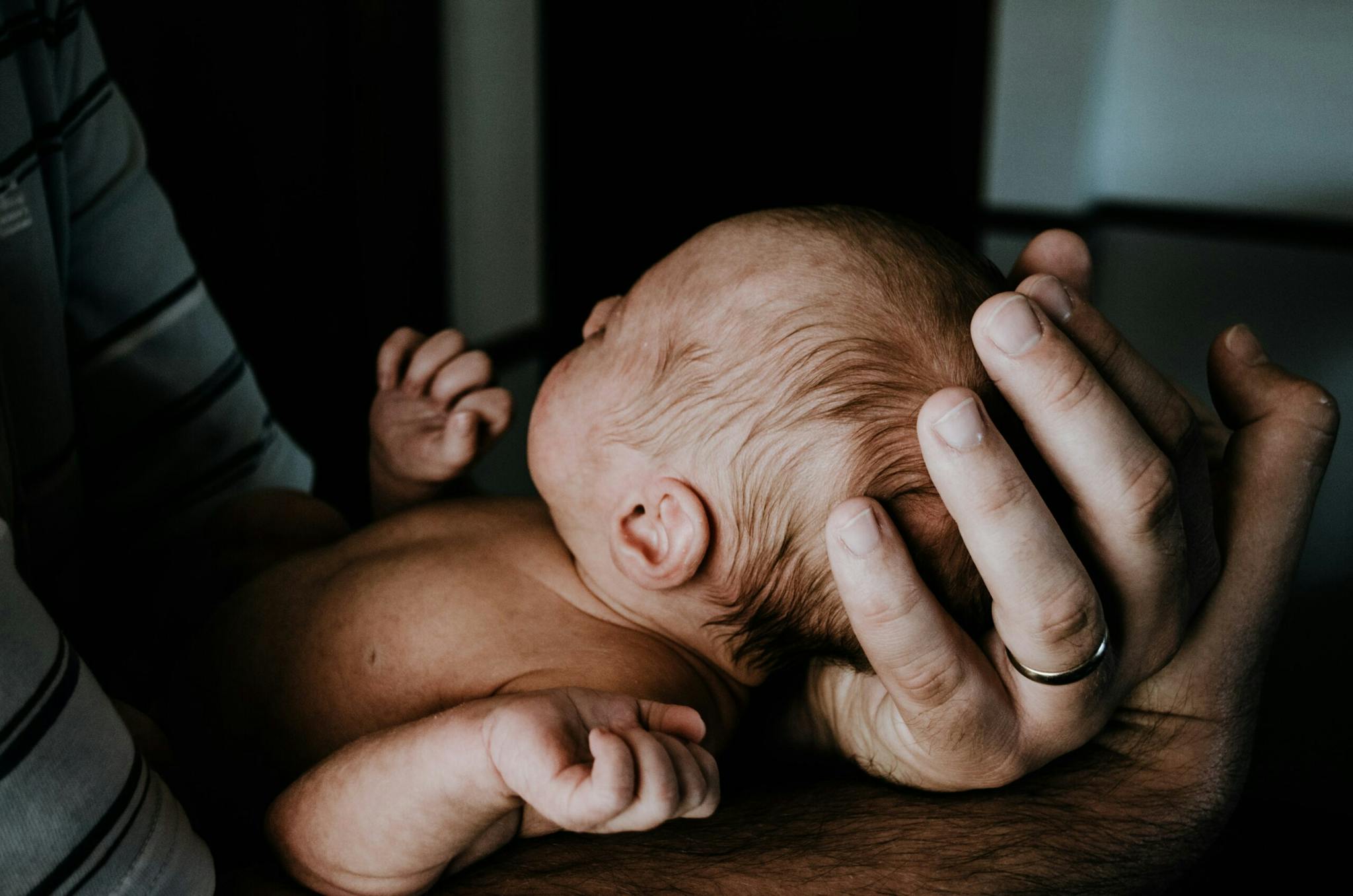 a baby lying on a person's chest