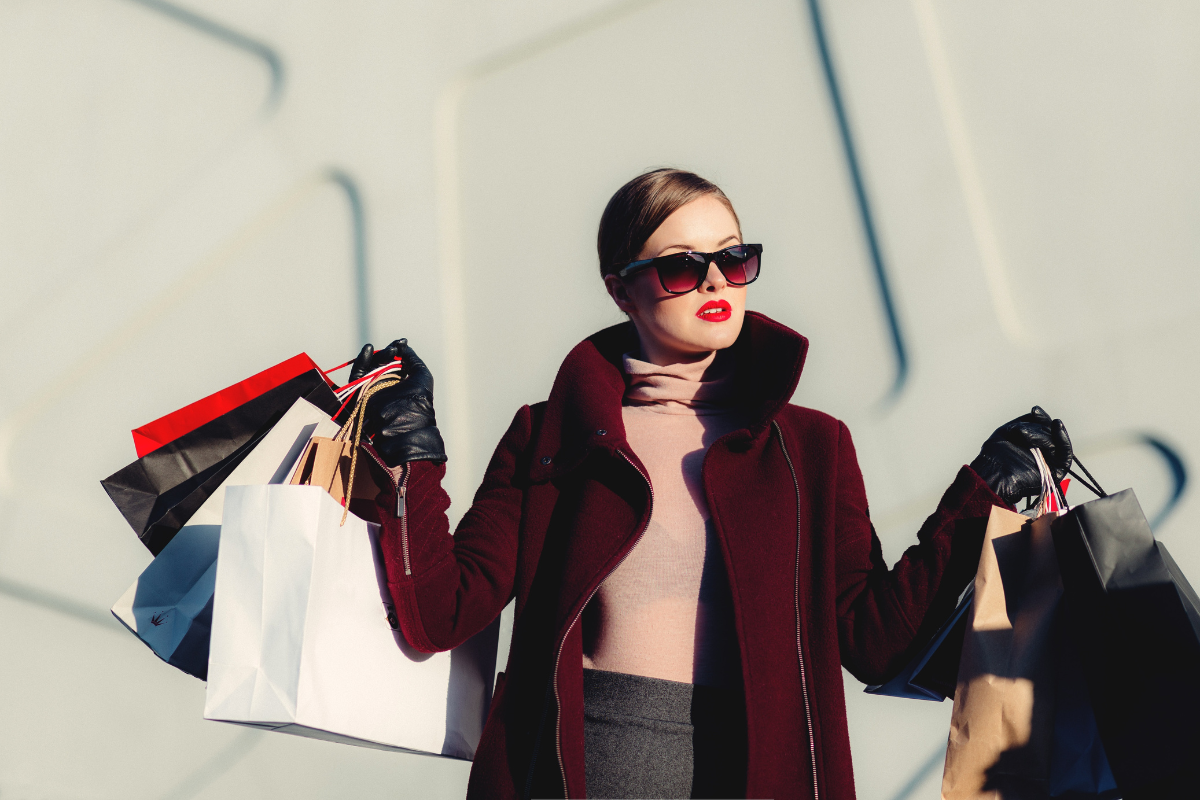 The girl has a shopping bag in her hand.