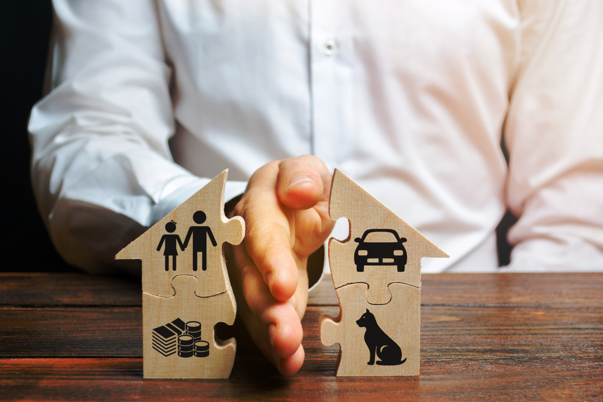 Man holding puzzle piece with house and family.