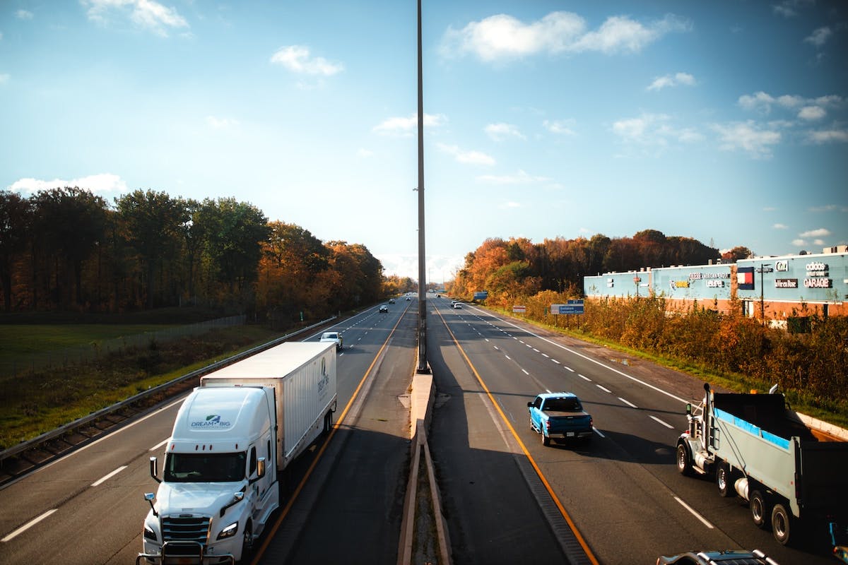 cars and trucks are moving on roads